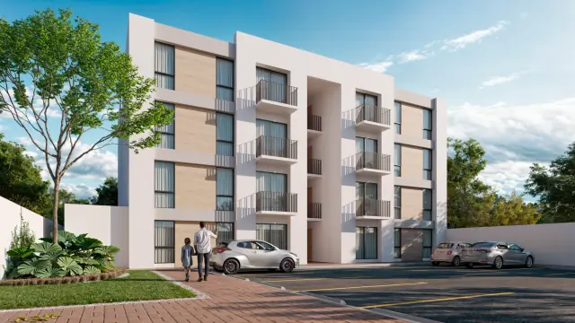 Vista lateral del edificio de Departamentos del Bosque con balcones y estacionamiento